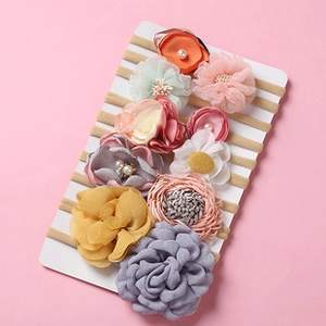 Detailed view of 10-piece baby nylon headbands with assorted fabric flowers on cards
