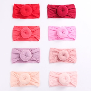 Set of 8 baby nylon headbands with doughnut knot detail in shades of pink and purple