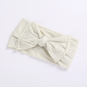 Soft elastic baby wide headband featuring a large bow in cream white color