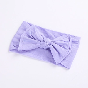 Detailed view of light purple baby headband with soft knit texture and large double bow