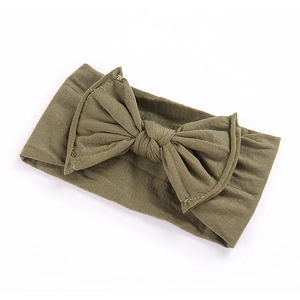 Dark green wide elastic baby headband with oversized knit bow on white background