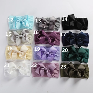 Detail showing 12 vibrant colors of soft elastic nylon headbands with ribbed ribbon bows