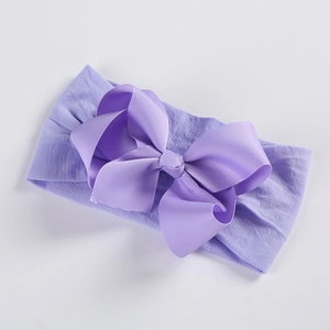 Close-up of light purple baby headband featuring a 5-inch grosgrain ribbon bow with soft nylon base