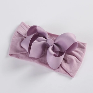 Detail of soft lilac nylon baby headband with a large textured grosgrain ribbon bow