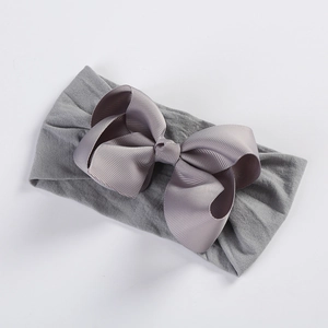 Detailed view of grey grosgrain ribbon bow on ultra-soft elastic nylon baby headband