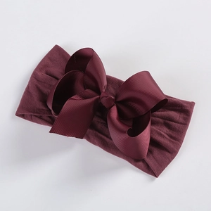 Detail of soft nylon infant headband with 5-inch dark red grosgrain ribbon bow