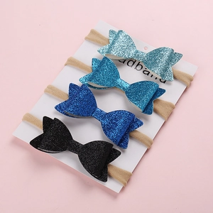 Set of four sequin bow nylon headbands for babies in shades of blue and black