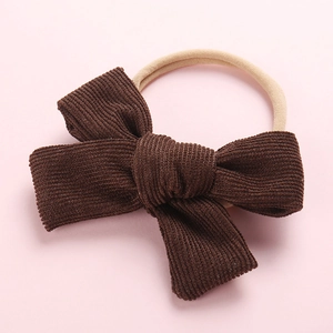Détail du bandeau à nœud en velours côtelé marron café avec élastique en nylon pour bébé