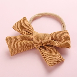 Bandeau bébé avec nœud en velours côtelé jaune moutarde et ruban en nylon élastique