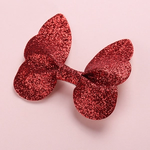 Detailed view of 3D glittery butterfly hair clip wings in a vibrant red sparkling finish
