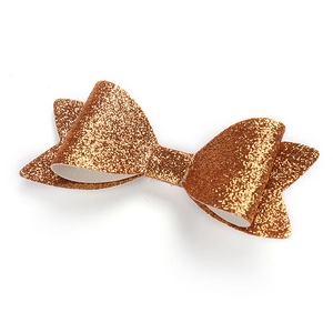Glitzernde goldene Schleifen-Haarspange für Mädchen mit Pailletten auf weißem Grund