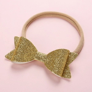 Detail of baby headband with gold glitter bow and soft nude nylon elastic band