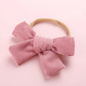 Bandeau bébé avec gros nœud en velours côtelé rose et bandeau en nylon élastique