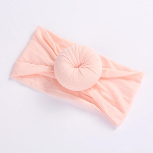 Soft nylon baby headband with large pleated donut knot in light pink color