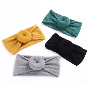 Set of four soft nylon baby headbands with donut ball knots in mustard, green, black and grey