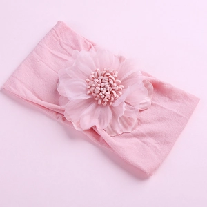 Macro detail of soft light pink baby headband with a layered chiffon mesh flower