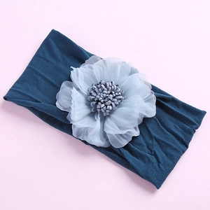 Detail of baby headband with oversized peacock blue chiffon flower and soft nylon band