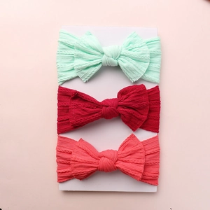 Three-piece baby bow headband set with ribbed knit nylon in mint, red, and coral pink