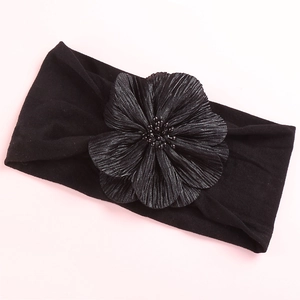 Detail of wide black nylon headband with a large handmade satin flower and beads