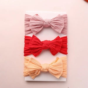 Three-piece set of knitted jacquard bow nylon headbands for babies in pink, red, and orange