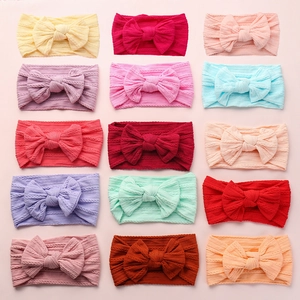 Set of fifteen colorful jacquard nylon bow headbands for baby girls in 5x3 grid layout
