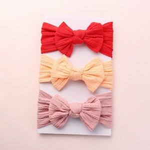 Three-piece set of jacquard knit baby headbands with large bows in red, orange, and pink colors