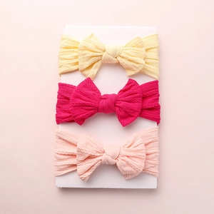 Three-pack of soft cable knit nylon baby headbands with large bows in bright vibrant colors