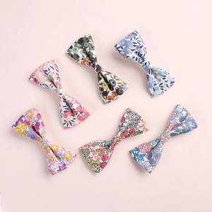 Détail de six pinces à cheveux à nœuds en coton floral aux motifs pastel variés
