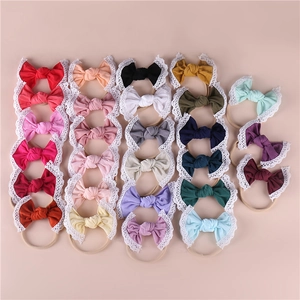 Detail showing various soft nylon baby headbands with lace edges and high-elasticity nude bands