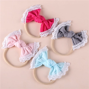 Set of 4 soft nylon baby headbands with lace-edged bows in pink, grey, and blue colors
