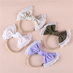 Detail view of baby lace bow headbands in cream, white, olive and lavender colors