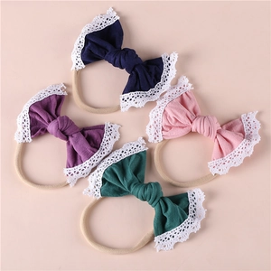 Close-up of baby headbands with delicate lace edges and soft cotton bow details