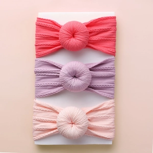Close-up of a 3-pack baby headband set with jacquard knit texture and donut knot style