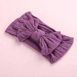 Close-up of soft purple cable knit texture and bow detail on the nylon baby headband