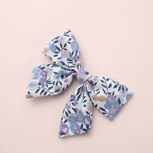 Floral cotton linen bow hair clip for girls with blue and purple flower patterns