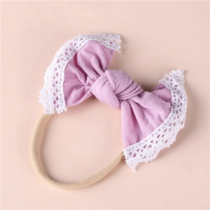 Close-up of baby headband with purple lace bow and soft high-elastic nylon band