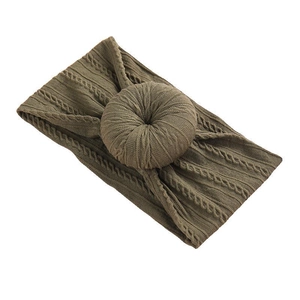 Olive green knitted baby headband featuring a donut knot and cable knit texture