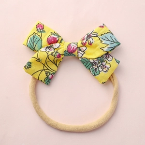 Floral yellow bow baby headband with strawberry print and soft nylon elastic band