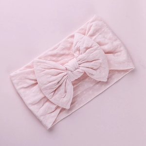Fascia per neonati in nylon rosa con un grande fiocco e tessuto testurizzato a stelle