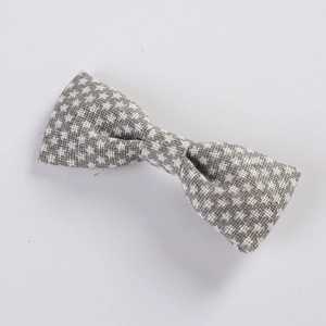 Close-up of grey and white checkered fabric bow hair clip with textured weave detail