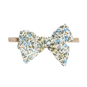 Floral print baby bow headband with blue and yellow patterns on a soft nylon band