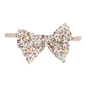 Detailed macro shot of floral print cotton bow on elastic baby headbands for infants