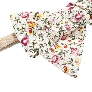 Macro shot of floral pattern bow headband with soft textured fabric and elastic nylon band