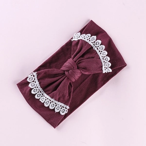 Detailed view of burgundy baby headband with soft lace embroidery and bow knot