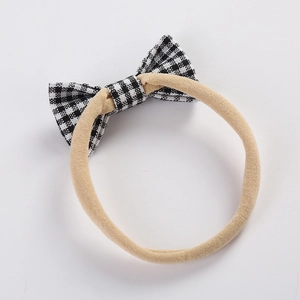 Soft nylon headband for babies featuring a black and white gingham checkered bow