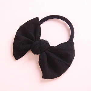 Close-up of soft black nylon baby headband with a large bow detail for girls