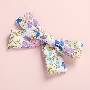 Floral print cotton bow hair clip for girls with pastel pink and purple flower patterns