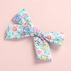 Detail of floral print mint green cotton bow hair clip with colorful flower pattern