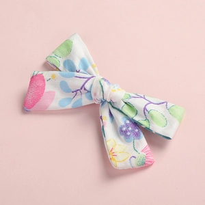 Detailed view of floral printed cotton bow hair clip with colorful flower patterns