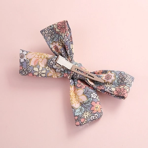 Detail of floral print cotton bow hair clip with silver metal alligator clip back